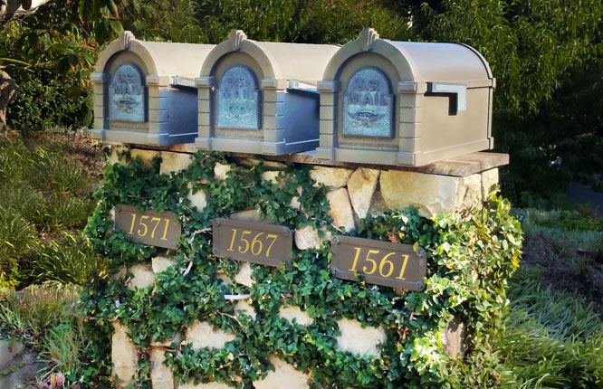 Three quaint ivy covered mailboxes
