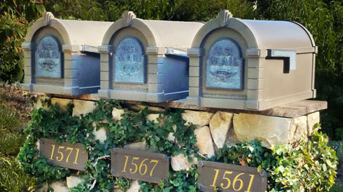Three quaint ivy covered mailboxes